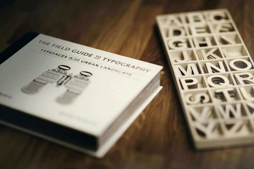 A typography field guide and alphabet letter tray showcasing creative design elements and trends.